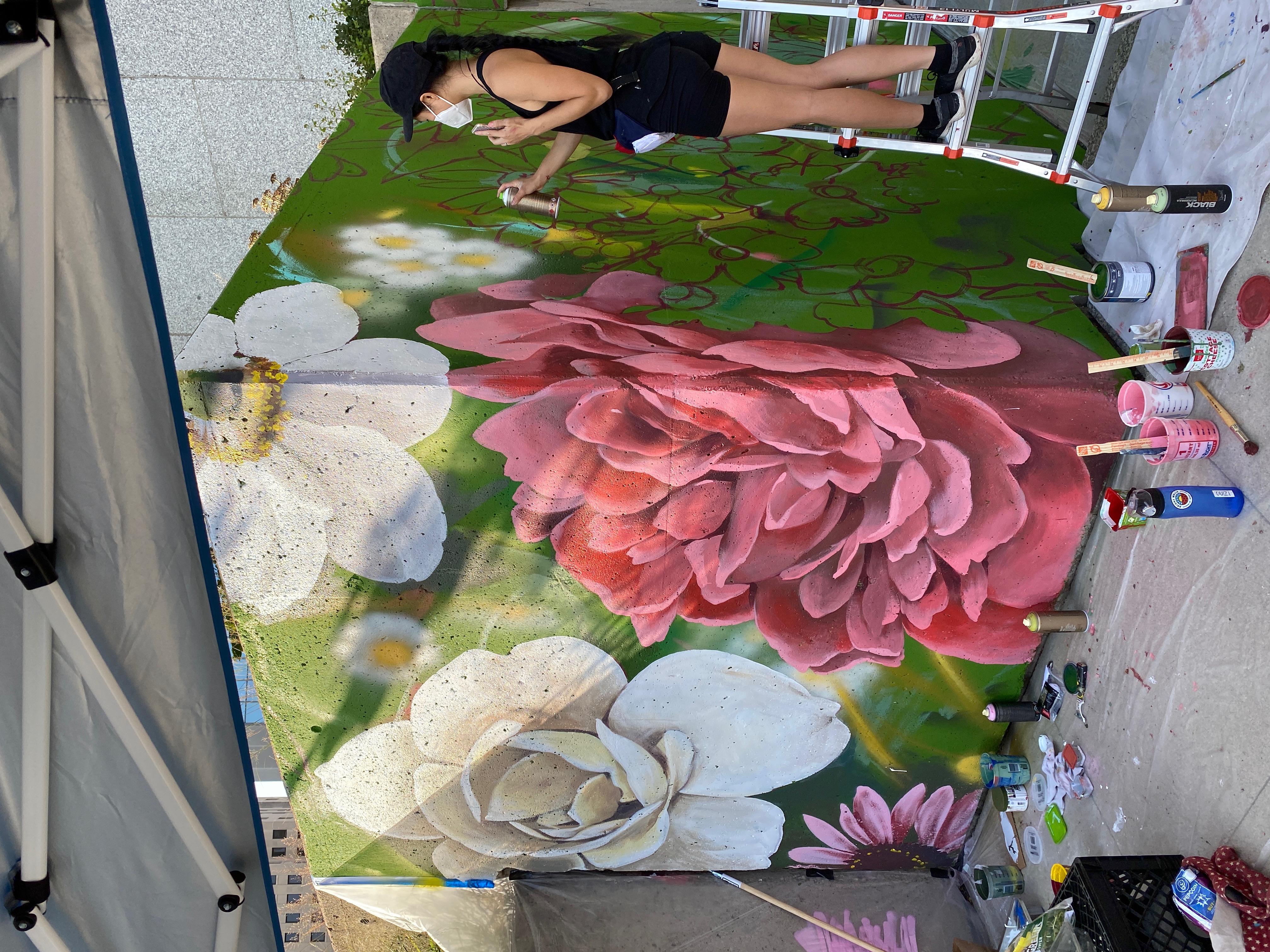 Local artist Louise Jones works on a mural. Photo courtesy of Crystal Phelps